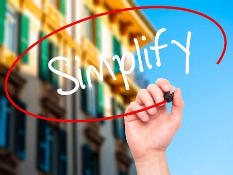 Man Hand writing Simplify with black marker on visual screen Stock Photos