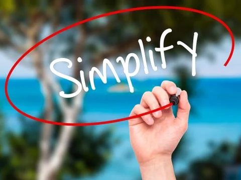 Man Hand writing Simplify with black marker on visual screen Stock Photos