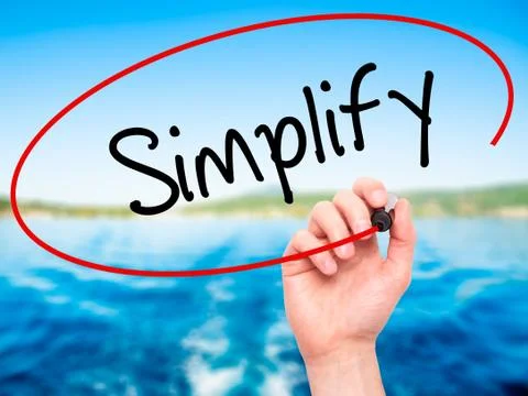 Man Hand writing Simplify with black marker on visual screen Stock Photos