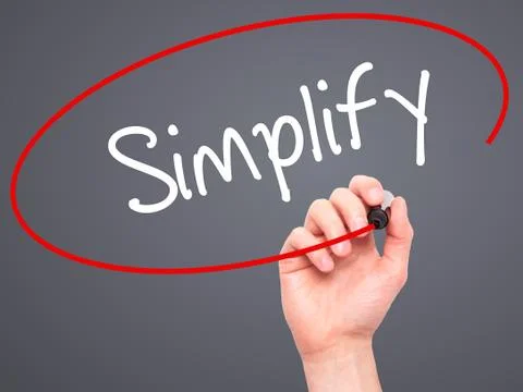 Man Hand writing Simplify with black marker on visual screen Stock Photos