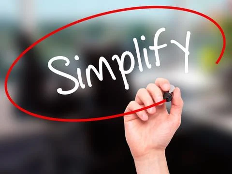 Man Hand writing Simplify with black marker on visual screen Stock Photos