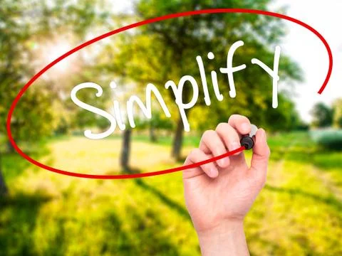 Man Hand writing Simplify with black marker on visual screen Stock Photos