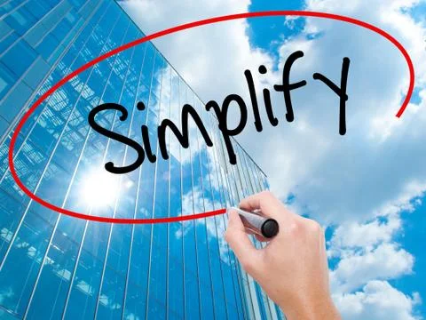 Man Hand writing Simplify with black marker on visual screen Stock Photos