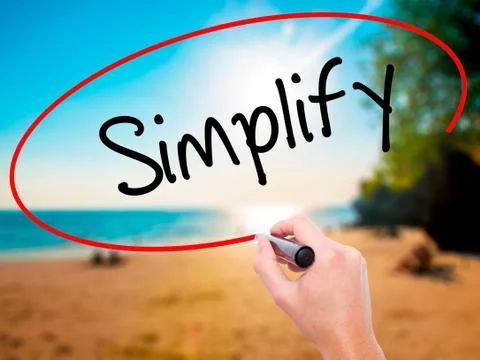 Man Hand writing Simplify with black marker on visual screen Stock Photos