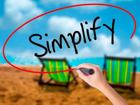 Man Hand writing Simplify with black marker on visual screen Stock Photos