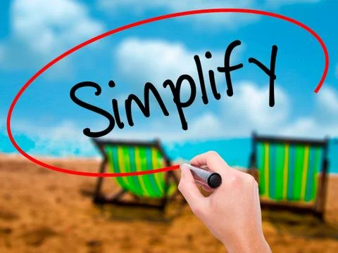 Man Hand writing Simplify with black marker on visual screen Stock Photos