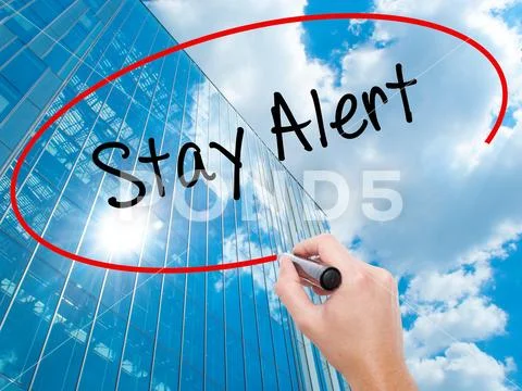 Man Hand writing Stay Alert with black marker on visual screen Stock Photos
