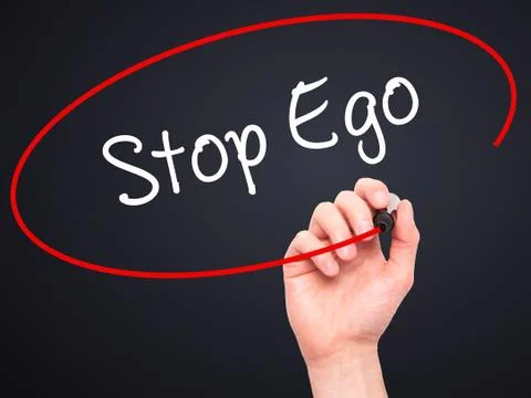 Man Hand writing  Stop Ego with black marker on visual screen Stock Photos