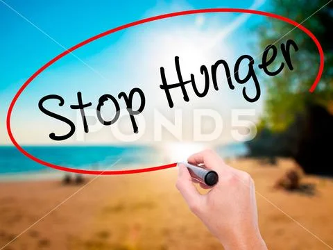 Man Hand writing Stop Hunger with black marker on visual screen Stock Photos