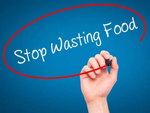 Man Hand writing Stop Wasting Food with black marker on visual screen Stock Photos