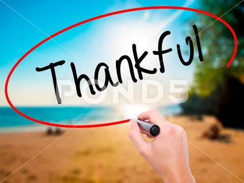 Man Hand writing Thankful with black marker on visual screen Stock Photos