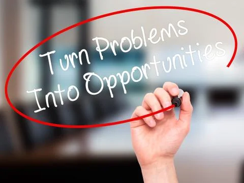Man Hand writing Turn Problems into Opportunities with black marker on visual Stock Photos