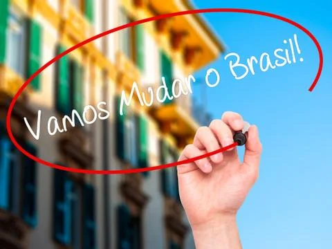 Man Hand writing Vamos Mudar o Brasil! (Let's Change Brazil in Portuguese) Stock Photos