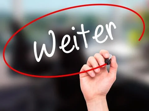 Man Hand writing Weiter (Continue in German)  with black marker on visual scr Stock Photos