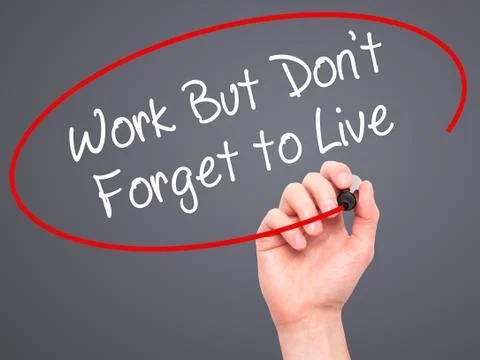 Man Hand writing Work But Don't Forget to Live  with black marker on visual s Stock-Fotos