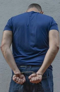 Man in handcuffs, back view Stock Photos