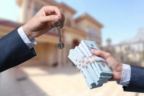 Man Handing a man Thousands of Dollars For Keys in Front of House. Stock Photos