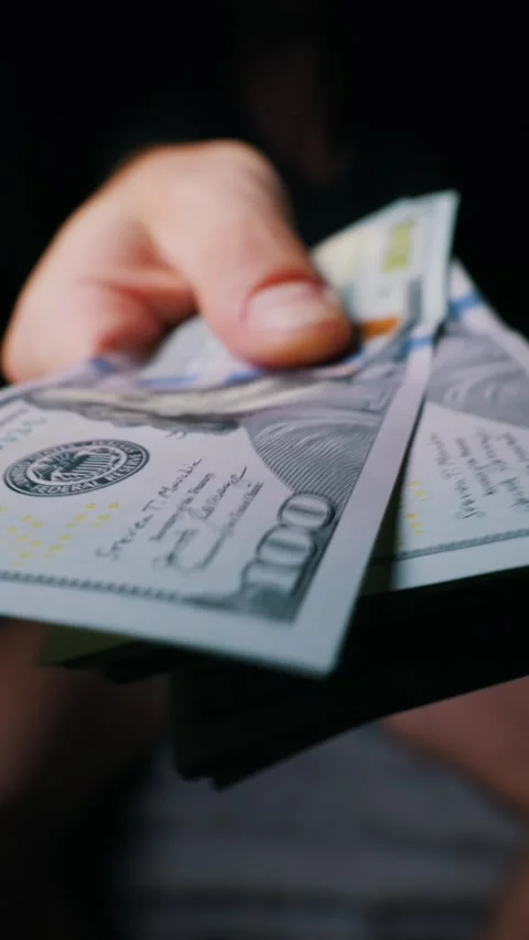 Man Handing Over Thick Stack of Us One Hundred Dollar Bills to Camera Stock Footage 339366768