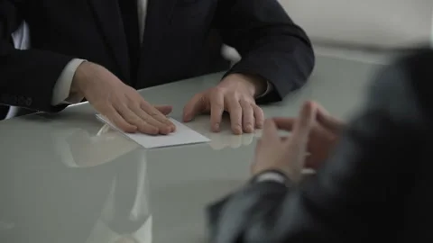 Man handing over white envelope with money, bribe to official, corruption 스톡 동영상 85706434
