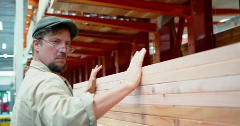 Man Handling Lumber in Warehouse Setting Stock Footage 323788397