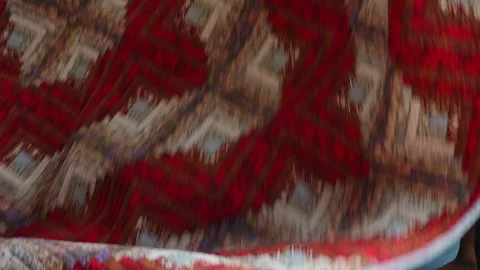 Man handling traditional patterned blanket during bedroom routine Vidéo 341994952