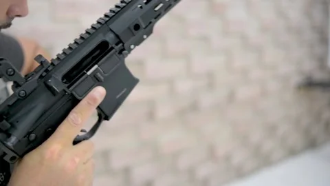Man handling weapon Stock Footage 167088058