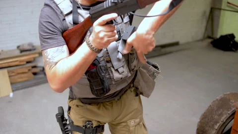 Man handling weapon Stock Footage 167088065