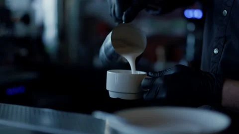 Man hands adding cream to coffee closeup. Bartender making cappuccino Video stock 201895952