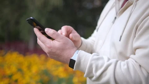 Man, hands and smartphone with typing, hiking in nature park and communication Stock Footage 250810856