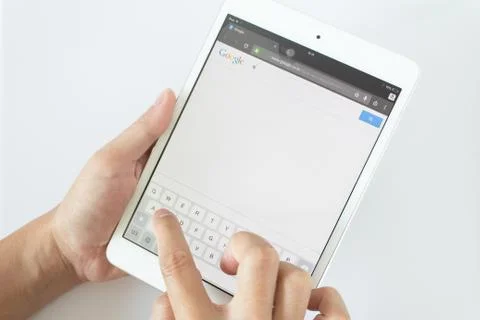 Man hands are pointing on touch screen device with google serch Stock Photos
