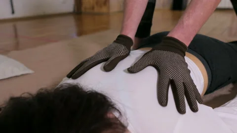 Man hands in black gloves makes a back massage to a girl Stock-Footage 149935405