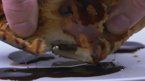 Man hands breaking a croissant covered with delicious chocolate syrup in slow mo Stock Footage 59666181