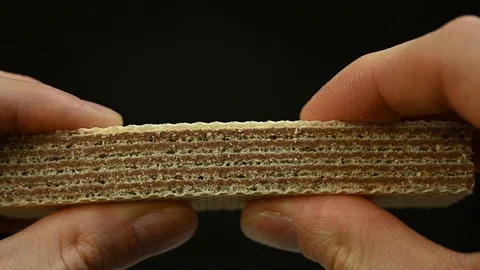 Man hands breaks biscuit waffle cookies Stock Footage 120685603