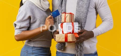 Man Hands Carrying Xmas Presents, Woman Hand With Credit Card
