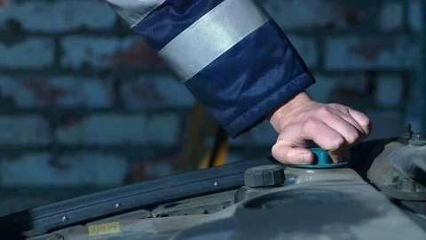 Man hands checking car oil level inside the garage. 4k Video stock 77489503