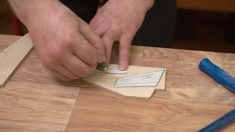 Man hands circle paper templates on jetliner wing model Stock Footage 126895756