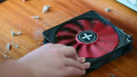 Man hands cleaning a computer fan cooling system with a brush slow motion Stock Footage 347437276