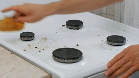 Man hands cleaning a kitchen cooker by yellow sponge Stock Footage 121338063