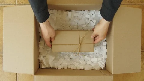 Man hands close a parcel contains a gift. Packing box with another box. Stock Footage 110730204