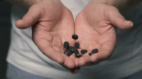 Man hands close up pouring activated carbon, taking medication. Health Video stock 169171182