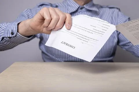Man hands closeup breaking contract. Termination of agreement, deal or employee Stock Photos