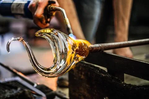 Man Hands Closeup Working on a Blown Glass Piece Фото