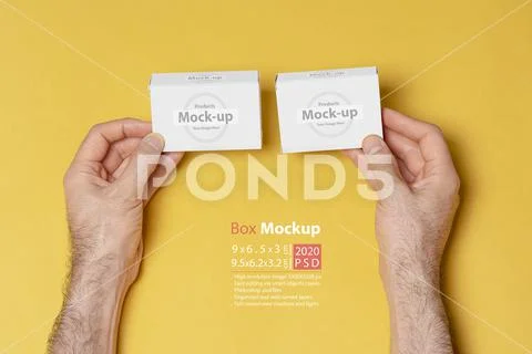 A man hands comparing two pillboxes in front of yellow background mock-up ser PSD Template