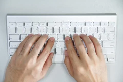 Man with hands on computer keyboard Stock Photos