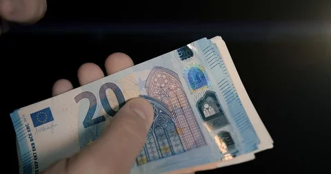 Man Hands Counting Euro Banknotes in a black environment Stockbeeldmateriaal 127634685
