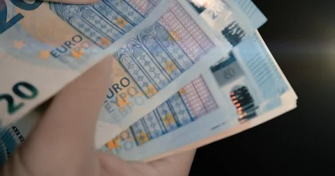 Man Hands Counting Euro Banknotes in a black environment Stockbeeldmateriaal 127691111