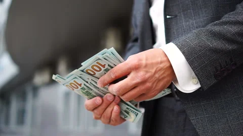 Man hands counting hundred dollar bills low angle shot Stock Footage 134457913