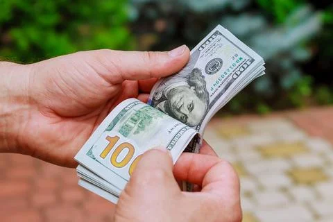 Man hands counting us dollar banknotes. Counting or spend money. Stock Photos