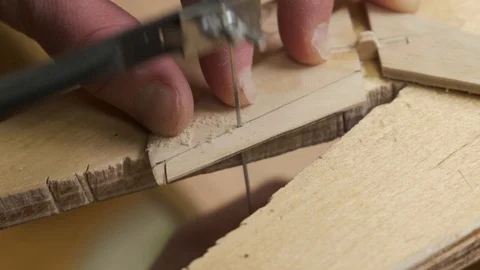 Man hands cut airplane model tail unit planes with fretsaw Stock Footage 127375290