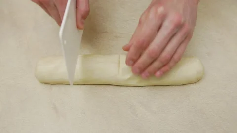 Man hands cut raw dough on the table, handmade cooking Stock Footage 222742581